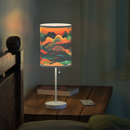 Mountain Muse - Lamp brings evening tranquility. This side table lamp combines sunset hues with abstract clouds and mountains for a serene ambiance. The unique graphical lampshade captures warmth, perfect for unwinding or bedtime. Its 20" × 7" size and white steel base suit any room, from living areas to nurseries, offering soothing illumination for all.